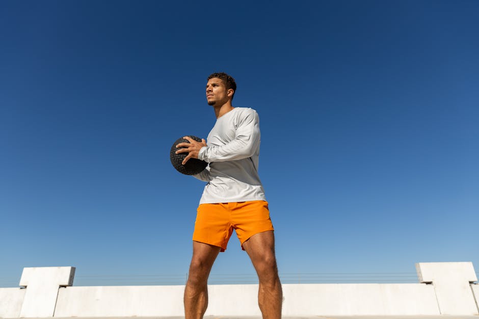 Young man exercising with medicine ball on a sunny Austin rooftop. Captured in vibrant detail.